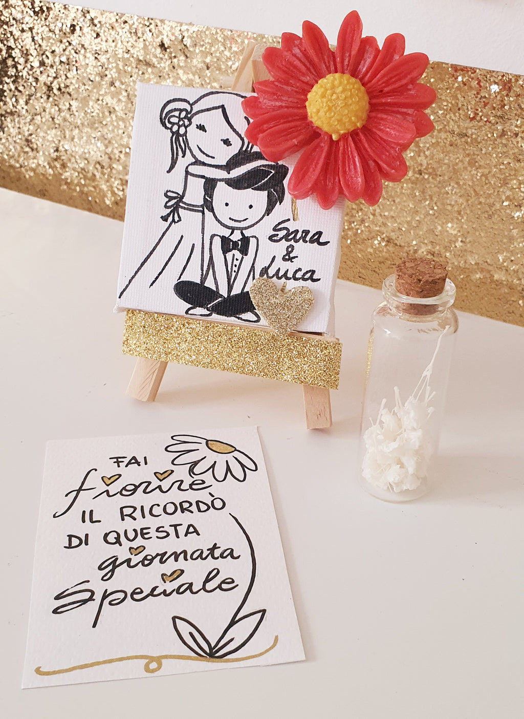 TELA CON FIORE IN CERA E DISEGNO E AMPOLLA CON SEMI DI FIORI