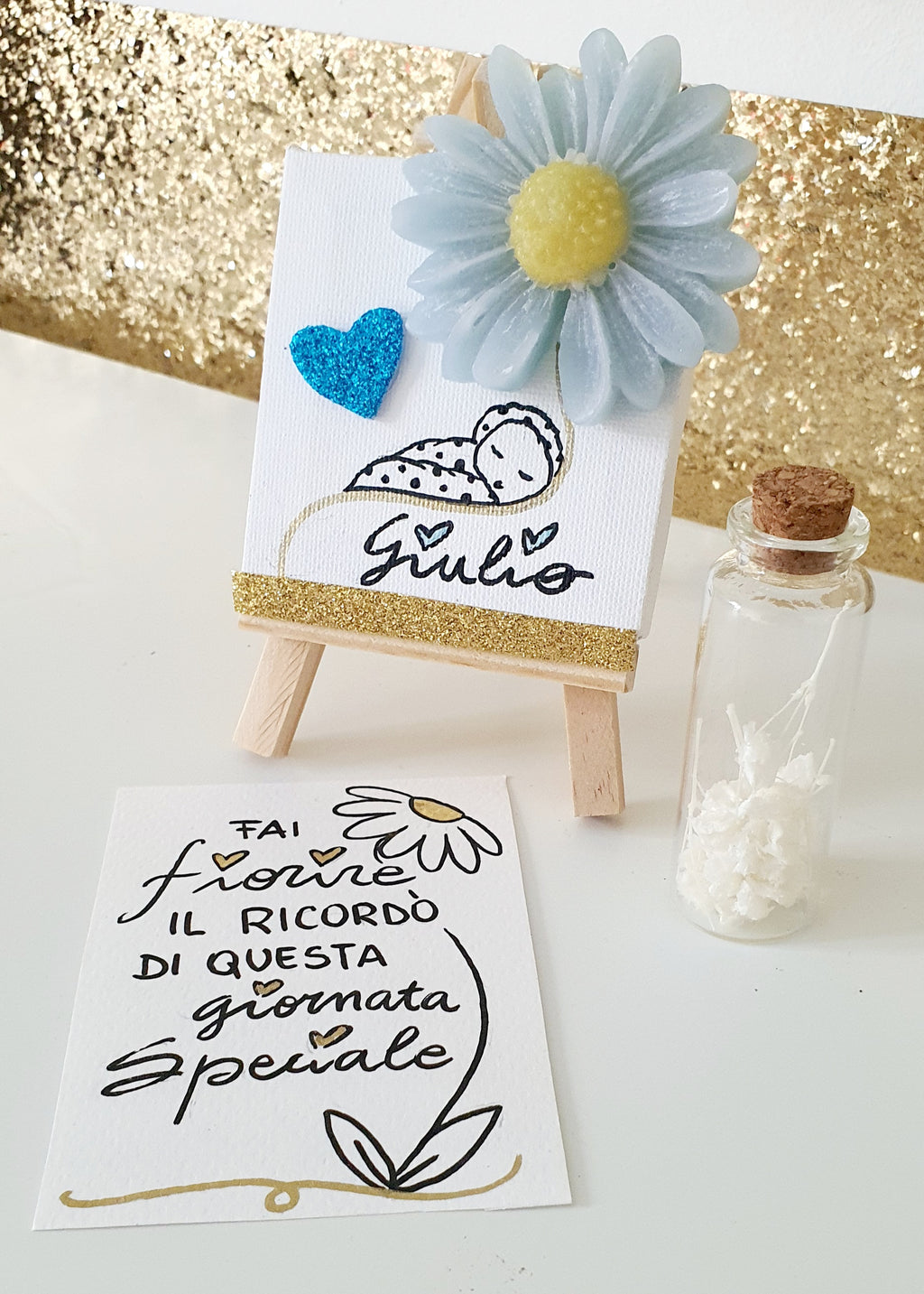 TELA CON FIORE IN CERA E DISEGNO E AMPOLLA CON SEMI DI FIORI
